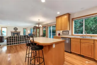 Large kitchen with island, pull out drawers and tile countertops.