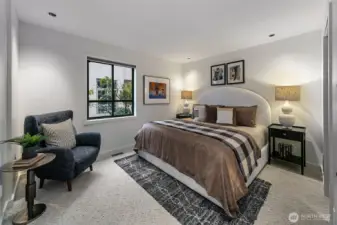 Spacious primary bedroom with brand new carpet.