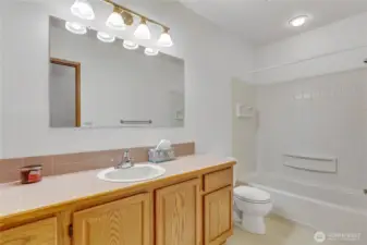 Full bath with a tub/shower combo.