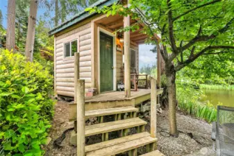 Charming powered sleeping cabin with Wi-Fi, pine paneling, and cozy loft beds.