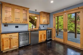 Wet bar with 3 tap kegerator, wine cooler and beverage fridge.