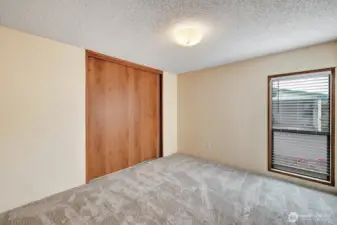 Guest bedroom #1 at the South end of the home. Great space for office, den or exercise space. Built in closet organizer with shelves for your convenience. Custom planation blinds for your privacy.