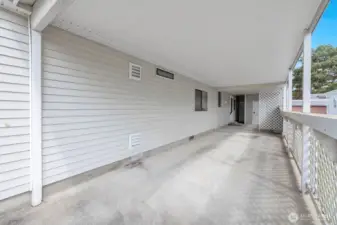 Deep carport will easily accommodate two standard sized vehicles and still have the space behind the 1/2 wall for storage of recycle totes etc.