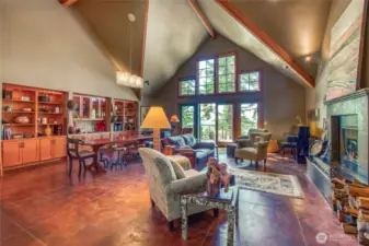 Spacious, warm and inviting...the main room of the home is the center of all activity with radiant heat in concrete floors, high ceilings, custom built-in cabinets and open to the kitchen and deck