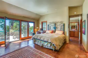Spacious primary has radiant heated concrete floor, walk in closet, and beaufiful tiled shower