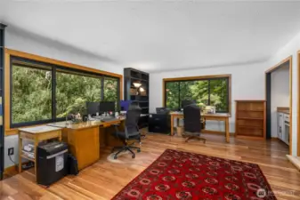 Gorgeous 2019 windows framed in VG fir enhance this room currently being used as an office by the owners.  It has a wet bar and could also serve as a formal dining room.