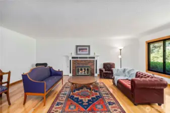 The formal living room features hardwood floors and a fireplace.