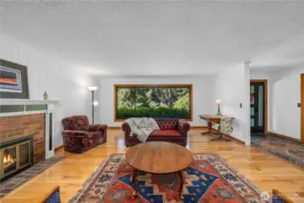 View two of the formal living room, the window looks over the mature landscaping at the front of the home