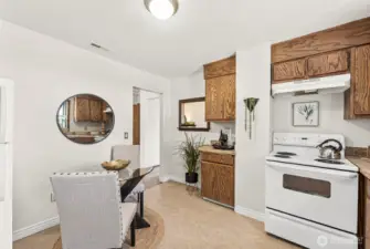 Crisp white appliances add a clean, classic look that complements the bright and airy feel of the eat-in area—perfect for enjoying morning coffee or casual meals.
