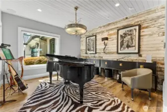 Formal Dining/Piano Room -  Designer, Michael Aram light fixture. Fence planking wall covering from the Kentucky Horse Park