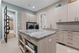 Downstairs laundry connected to primary bedroom closet