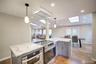 This kitchen with quartz counter tops is situated for entertaining, you can see into the dining room and living room.