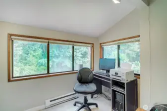 Den/office upstairs has lots of windows that look out at all the trees. New carpet installed.