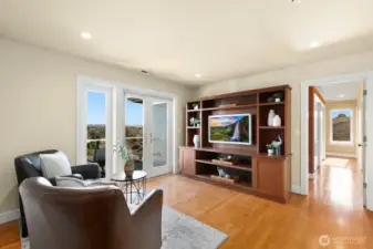 Now upstairs where you are greeted with a TV/sitting area and French doors onto the view deck.