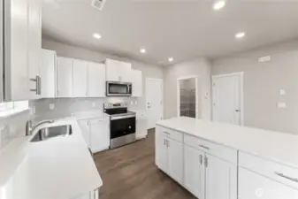 Natural light pours into the great room from a wall of windows, highlighting the open and airy design.  Pictures are for representational purposes only, colors and features may vary.