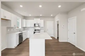 Open sight lines from the great room to the kitchen and staircase make the space feel connected and expansive.  Pictures are for representational purposes only, colors and features may vary.