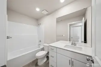 Bright and functional upstairs bathroom featuring a clean tub/shower combo, quartz vanity, and modern lighting.  Pictures are for representational purposes only, colors and features may vary.