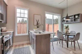 **Photos are of Unit B, for illustrative purposes only. Unit C has all the same finishes w/reversed floor plan.** Dining area with access to a fully-fenced private patio.
