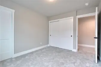 **Photos are of Unit B, for illustrative purposes only. Unit C has all the same finishes w/reversed floor plan.** Guest bedroom with two closets for plenty of storage space.