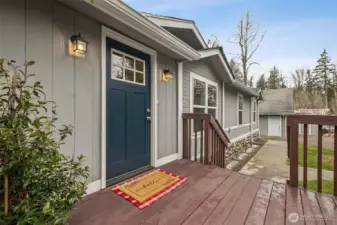 A welcoming front deck creates a warm first impression the moment you arrive. The wide, inviting space is perfect for relaxing with morning coffee or greeting guests in a comfortable outdoor setting. It sets the tone for the home’s peaceful, private atmosphere before you even step inside.
