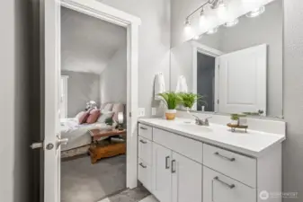 The en-suite primary bath has been updated with modern tile and fixtures. Clean lines and contemporary finishes create a spa-like feel. It’s a private space to unwind at the end of the day.