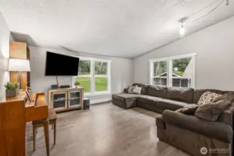 The family room’s generous size allows for multiple furniture arrangements. It’s a versatile space that can evolve with your needs. Comfort and functionality come together beautifully here.