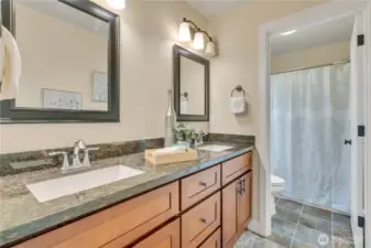 Primary suite bath with duel sinks and oversized mirrors.  Separate room for tub/shower & toilet.  Makes getting ready just a bit easier!