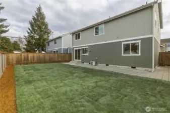 Fully Fenced back yard; luscious new sod & planting border. Patio and hard-scape that extends around the home.