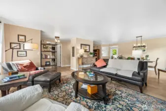Standing near the front windows, you really start to see how naturally this living room connects to the rest of the home. The space moves easily toward the dining area and loops back to the entry in a way that feels intuitive the second you walk it. There’s no awkward stopping point or furniture Tetris required here, just a smooth circular flow that keeps daily life feeling organized and gatherings feeling relaxed. From this vantage point you can also spot the laundry room door right near the entry, which is one of those practical touches you appreciate more over time. It keeps real life contained without pulling attention away from the main living spaces.