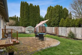 Tucked into the far corner, the shed and greenhouse combo is basically a love letter to anyone with a green thumb. Early seed starts, overwintering favorites, potting projects that somehow take over your weekends, it all has a proper home here. There is so much open yard to design garden beds, pollinator patches, or even a mini orchard moment if that’s your thing. Mature privacy hedging in the neighboring yards helps frame the space with a soft, leafy backdrop, giving this backyard a peaceful, tucked-away vibe that feels surprisingly private for everyday living.