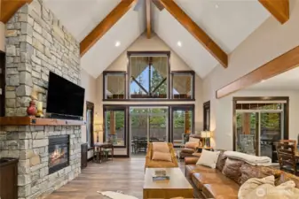 Great Room with large fireplace and soaring windows