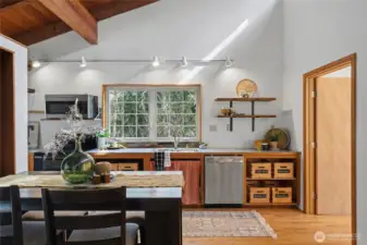 Large windows above the sink draw in calming forest views, turning everyday routines into something special.