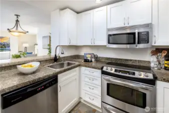 The galley kitchen keeps the connection to light and water present, shaping everyday moments and meals