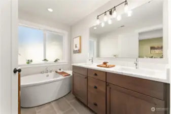 Primary full bathroom with double sinks and free standing tub