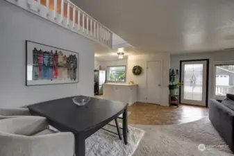 Dining area and kitchen with the main entry.