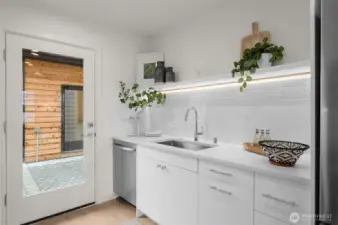 Details that shine. Under-cabinet lighting, timeless subway tile, and sleek fixtures elevate every dish you rinse or glass you pour.