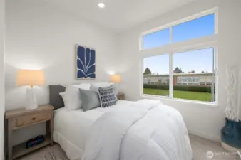 This sunlit bedroom is your peaceful retreat, with large windows that frame green views and fill the room with calming light—morning person or not, you’ll love waking up here.