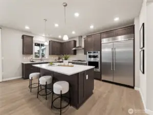 Gourmet Kitchen with upgraded appliances.    Check out the 48" included built-in Fridge. Photo is representational. Actual home is under construction and finishes and colors will vary. See site agent for details.