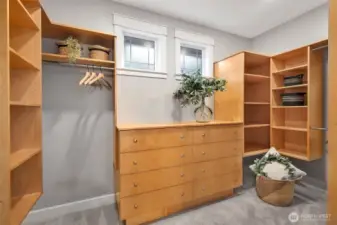 Primary walk in closet with custom built ins.