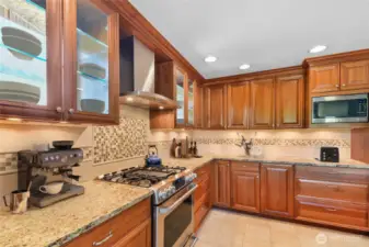 So much counter space.  The glass cabinets with shelves are a true focal point.Fantastic 2 story located in the highly sought after Tuscany neighborhood! This light & bright 4 bdrm on a huge corner lot is the one you have been waiting for! Open floor plan has a separate Living, Family, & Dining room, perfect for entertaining. Chef’s kitchen has all the bells & whistles including Maple cabinets, huge island w/sink, bay window, tons of pull outs including a mixer cabinet that pulls out to counter level, & beautiful glass cabinets w/shelves! Radiant heated travertine stone tile in the kitchen is amazing!