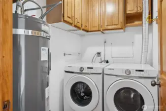 Spacious laundry room with ample storage and updated cabinetry.