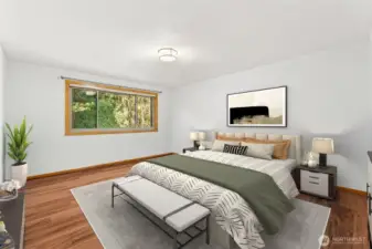 Spacious primary bedroom with private bath and walk-in closet.