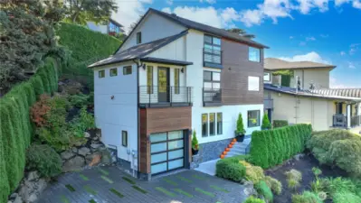 Front approach showcasing timeless curb appeal and mature Northwest landscaping around the home.