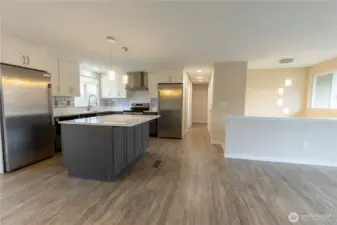 From dining room looking down hall past the kitchen to the upstairs bedrooms. Crystal light fixtures.