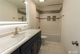 Full bath with custom tile. Anti-fog mirror.