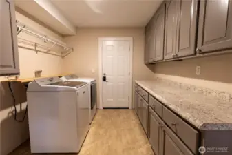Laundry room showing door to back patio.