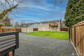 Back of home showing deck. Outbuilding with power. fully fenced yard.