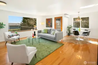 The living and dining areas are bright and cheery. The entrance to the deck is just behind the couch.