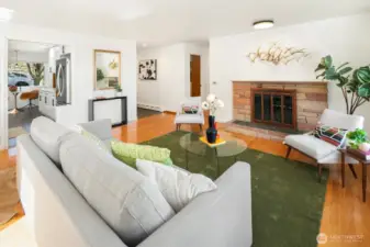 Hallway to the bedrooms is to the left of the fireplace.