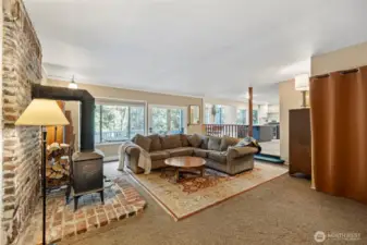 Huge family room with wood stove and double doors to deck.